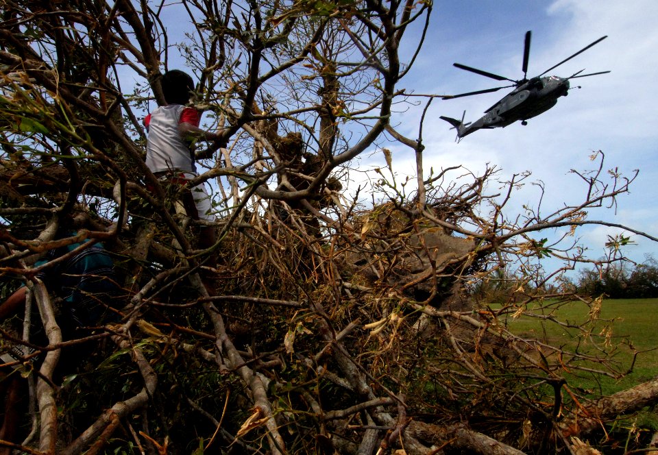 US Navy 070907-N-1810F-043 Children watch an MH-53 helicopter from USS Wasp (LHD 1) deliver food and water during Hurricane Felix disaster relief operations