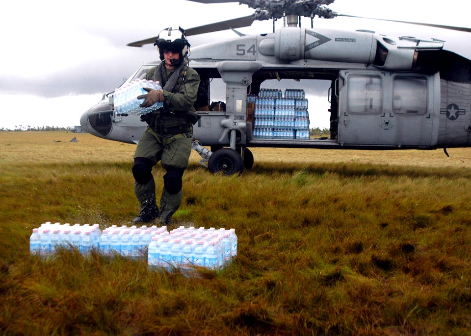 US Navy 070907-N-1189B-221 U.S. Navy aircrewman attached to USS Wasp (LHD 1) unloads water during disaster relief efforts in Nicaragua photo