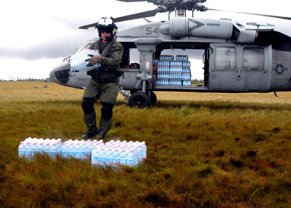 US Navy 070907-N-1189B-221 U.S. Navy aircrewman attached to USS Wasp (LHD 1) unloads water during disaster relief efforts in Nicaragua