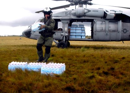 US Navy 070907-N-1189B-221 U.S. Navy aircrewman attached to USS Wasp (LHD 1) unloads water during disaster relief efforts in Nicaragua photo
