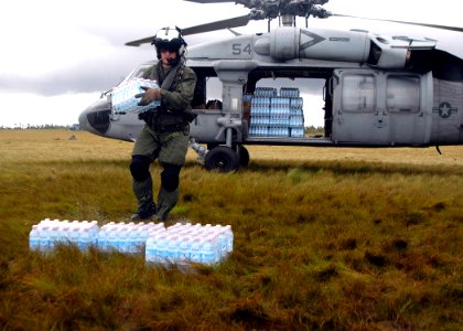 US Navy 070907-N-1189B-221 U.S. Navy aircrewman attached to USS Wasp (LHD 1) unloads water during disaster relief efforts in Nicaragua