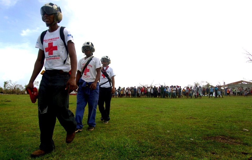 US Navy 070907-N-1810F-072 Red Cross volunteers participating in Hurricane Felix disaster relief operations prepare to distribute food and water