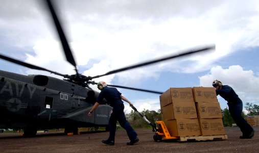 US Navy 070907-N-1810F-018 Amphibious assault ship USS Wasp (LHD 1) crew members load U.S. AID supplies onto an MH-53E helicopter, for delivery to residents of areas affected by Hurricane Felix photo