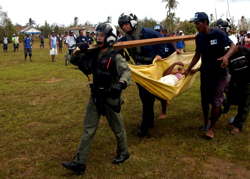 US Navy 070907-N-1189B-210 U.S. Navy aircrewmen attached to USS Wasp (LHD 1) carry an injured Nicaraguan woman to a helicopter for a medical evacuation