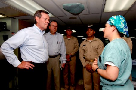 US Navy 070907-N-6278K-036 Lt. Cmdr. Tracey Kunkel, division officer of the main operating room aboard Military Sealift Command hospital ship USNS Comfort (T-AH 20), explains operating room procedures to Secretary of Health and