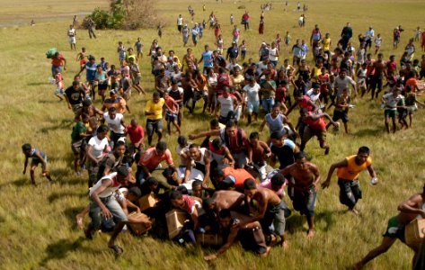 US Navy 070907-N-1189B-045 Citizens of Puerto Cabezas rush to get Meals Ready to Eat (MRE) that were dropped from an MH-60S Seahawk helicopter attached to the multi-purpose amphibious assault ship USS WASP (LHD 1)