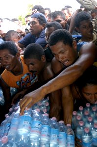 US Navy 070907-N-1189B-023 Citizens from Puerto Cabezas get bottled water from an MH-60S Seahawk helicopter attached to the multi-purpose amphibious assault ship USS Wasp (LHD 1) photo