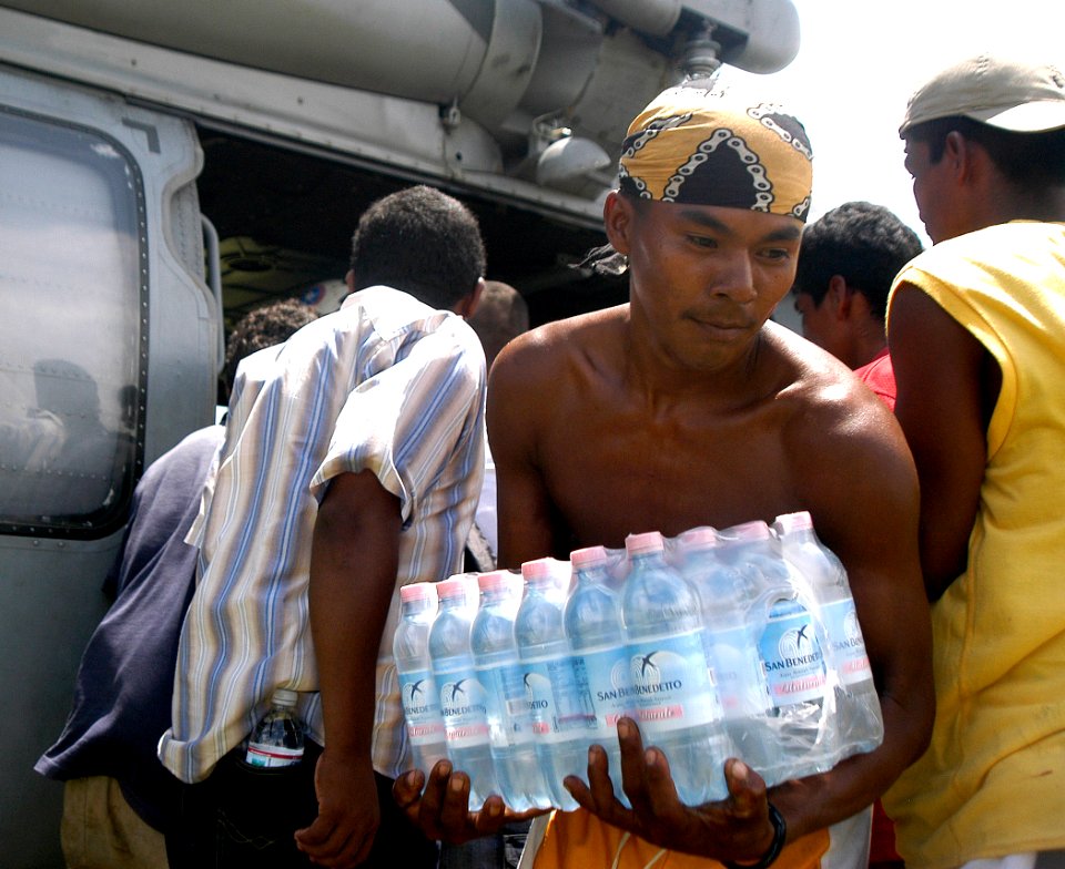 US Navy 070907-N-1189B-064 A citizen from Puerto Cabezas takes bottled water from an MH-60S Seahawk helicopter attached to the multi-purpose amphibious assault ship USS Wasp (LHD 1)