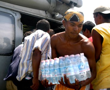 US Navy 070907-N-1189B-064 A citizen from Puerto Cabezas takes bottled water from an MH-60S Seahawk helicopter attached to the multi-purpose amphibious assault ship USS Wasp (LHD 1) photo