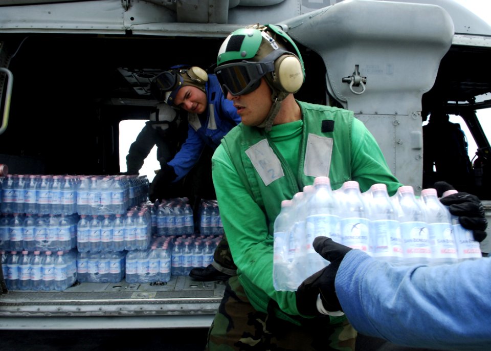 US Navy 070907-N-7540C-040 Sailors aboard the multi-purpose amphibious assault ship USS Wasp (LHD 1), load disaster relief supplies