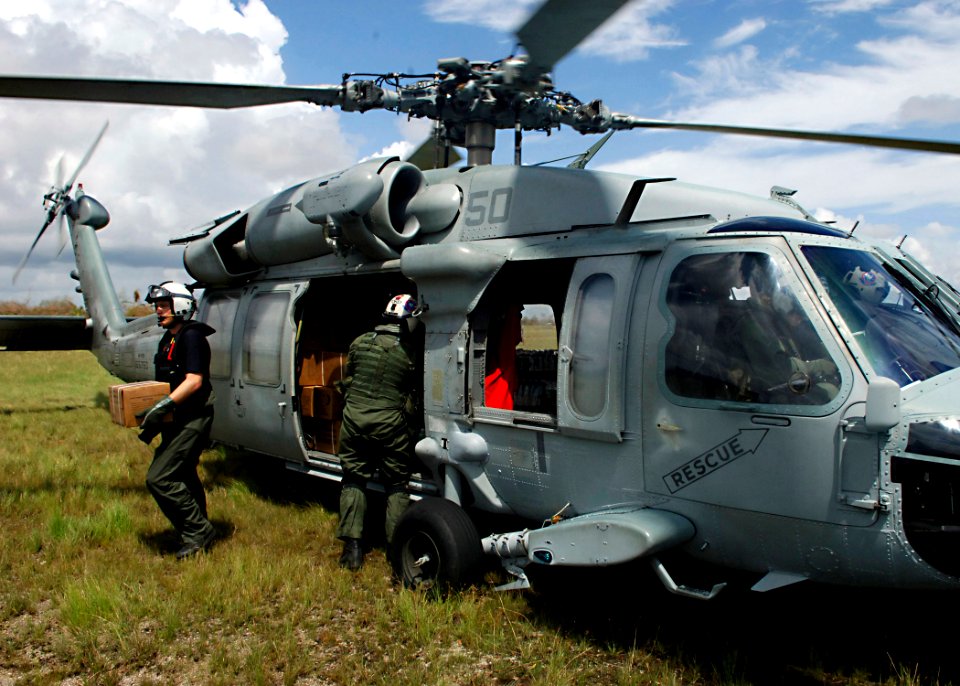 US Navy 070907-N-7540C-061 U.S. Navy aircrewmen from the multi-purpose amphibious assault ship USS Wasp (LHD 1) carry boxes of food from a helicopter during relief efforts in Nicaragua