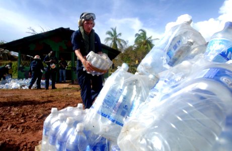 US Navy 070907-N-1810F-074 Amphibious assault ship USS Wasp crew members participating in Hurricane Felix disaster relief operations prepare water for delivery to local residents photo