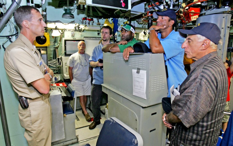 US Navy 070907-N-7441H-005 Lt. Cmdr. Rich Rhinehart, executive officer of USS Norfolk (SSN 714), welcomes celebrities Raghib Rocket Ismail, Andre Reed and Jamie Farr to the attack submarine's control room