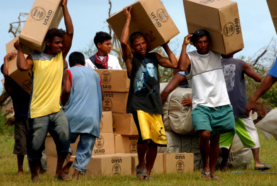 US Navy 070907-N-1810F-048 Nicaraguans carry supplies delivered by helicopters from the amphibious assault ship USS Wasp (LHD 1)