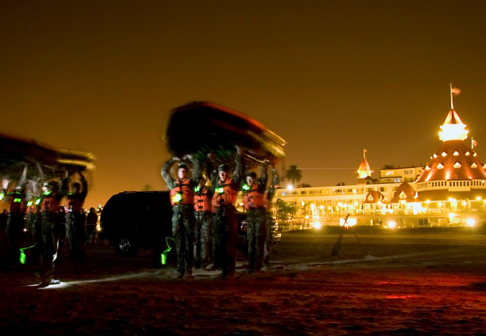 US Navy 070910-N-7202B-001 Students from Basic Underwater Demolition-SEAL (BUD-S) class 267 spend the night carrying heavy boats up and down the beach during the middle of Hellweek