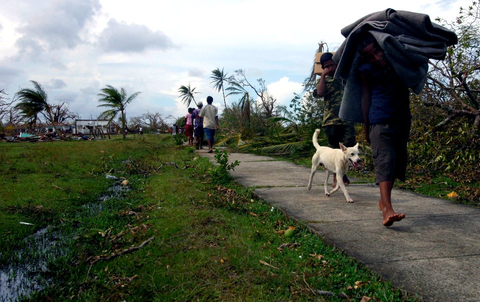 US Navy 070907-N-1810F-068 Nicaraguan citizens carry boxes of Meals Ready-to-Eat (MREs) to their homes after the food was delivered by Sailors attached to multi-purpose amphibious assault ship USS Wasp (LHD 1) photo