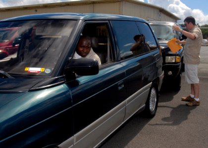 US Navy 070910-N-9758L-075 Storekeeper 3rd Class Jonathan Woodruff, assigned to Naval Surface Group Middle Pacific, assists Storekeeper 2nd Class Patrick Bowens move a vehicle at Naval Station Pearl Harbor
