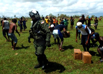 US Navy 070907-N-7540C-019 A U.S. Navy air crewman distributes relief supplies flown in from the multi-purpose amphibious assault ship USS Wasp (LHD 1)