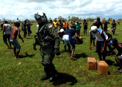 US Navy 070907-N-7540C-019 A U.S. Navy air crewman distributes relief supplies flown in from the multi-purpose amphibious assault ship USS Wasp (LHD 1) photo