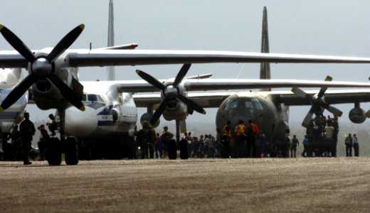 US Navy 070907-N-1810F-077 U.S. and Nicaraguan military personnel unload supplies from cargo aircraft during Hurricane Felix disaster relief operations photo