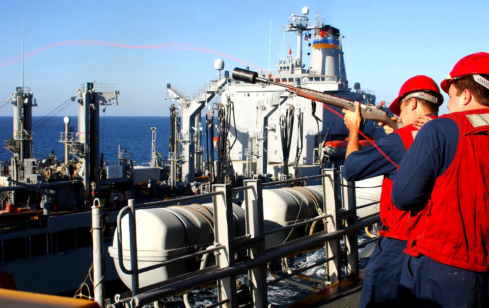 US Navy 070908-N-4774B-026 Aviation Ordnanceman 1st Class Dennis Guernsey uses an M14 rifle to shoot a messenger line from amphibious assault ship USS Tarawa (LHA 1) to Military Sealift Command fleet replenishment oiler USNS Yu