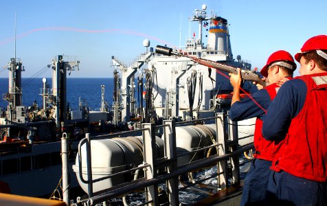 US Navy 070908-N-4774B-026 Aviation Ordnanceman 1st Class Dennis Guernsey uses an M14 rifle to shoot a messenger line from amphibious assault ship USS Tarawa (LHA 1) to Military Sealift Command fleet replenishment oiler USNS Yu