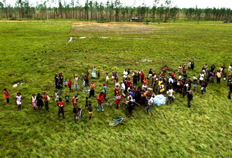 US Navy 070907-N-7540C-036 ocal citizens gather around relief supplies of food and water delivered by U.S. Navy helicopters
