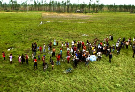 US Navy 070907-N-7540C-036 ocal citizens gather around relief supplies of food and water delivered by U.S. Navy helicopters photo