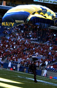 US Navy 070908-N-2143T-029 A member of U.S. Navy Parachute Demonstration Team, the Leap Frogs, lands on Qwest Field before a ceremony honoring Master-at-Arms 2nd Class Michael A. Monsoor, a Navy SEAL who died in Ramadi, Iraq, S