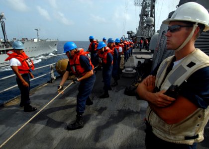 US Navy 070909-N-0841E-433 Sailors aboard guided-missile frigate USS Carr (FFG 52) heave on a line to bring in the fuel probe during a refueling at sea with Military Sealift Command fleet replenishment oiler USNS Tippecanoe (T