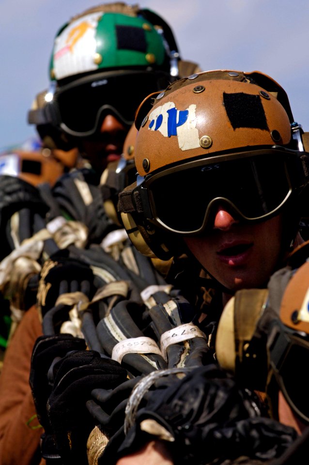 US Navy 070911-N-7883G-011 Flight deck personnel stow an aircraft barricade during damage control drills aboard aircraft carrier USS Kitty Hawk (CV 63)
