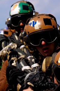 US Navy 070911-N-7883G-011 Flight deck personnel stow an aircraft barricade during damage control drills aboard aircraft carrier USS Kitty Hawk (CV 63)