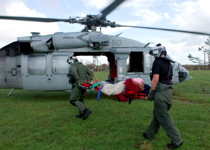 US Navy 070907-N-7540C-005 Sailors assigned to multi-purpose amphibious assault ship USS Wasp (LHD 1) carry an injured Nicaraguan woman to a helicopter as they prepare for a medical evacuation