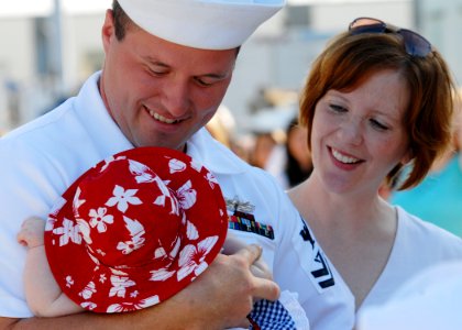 US Navy 070911-N-9909C-194 Fire Controlman 2nd Class Jeremy Bondy, assigned to guided-missile frigate USS Jarrett (FFG 33), holds his 3-month-old daughter for the first time