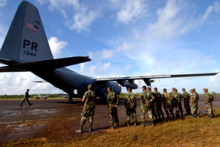 US Navy 070908-N-1810F-010 Nicaraguan army soldiers prepare to unload supplies from a U.S. Navy C-130T aircraft during Hurricane Felix disaster relief operations photo