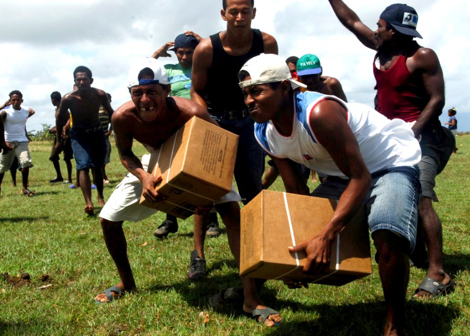 US Navy 070907-N-7540C-017 Local citizens clear away from a U.S. Navy helicopter after the aircraft delivered food and water supplies