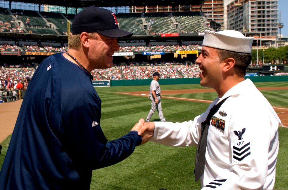 US Navy 070909-N-5319A-003 Fire Controlman 1st Class John Michael Broughton shakes hands with Boston Red Socks pitcher Curt Schilling before an Orioles-Red Sox game at Camden Yards