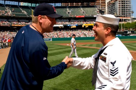 US Navy 070909-N-5319A-003 Fire Controlman 1st Class John Michael Broughton shakes hands with Boston Red Socks pitcher Curt Schilling before an Orioles-Red Sox game at Camden Yards