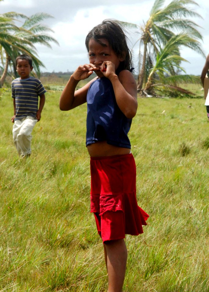 US Navy 070907-N-7540C-034 A young girl stares at the camera while U.S. Sailors attached to USS Wasp (LHD 1) provide humanitarian assist to the local populace in the aftermath of Hurricane Felix
