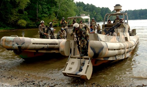 US Navy 070910-N-6639M-043 Sailors assigned to Riverine Squadron (RIVRON) 2 come ashore with two simulated detainees to be turned over to Mobile Security Squadron 3, Det. 33, during COMET 2007