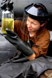 US Navy 070912-N-7883G-002 Aviation Structural Mechanic 3rd Class Laura Belko takes fuel samples from an HH-60H Seahawk, attached to the Chargers of Helicopter Anti-Submarine Squadron (HS) 14, aboard USS Kitty Hawk (CV 63)