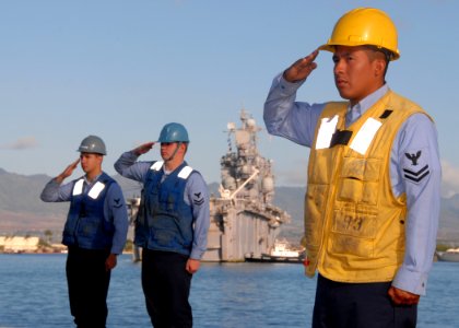 US Navy 070912-N-4965F-007 Sailors of the Pearl Harbor-based guided-missile destroyer USS Paul Hamilton (DDG 60) salute during morning colors as Tarawa-class amphibious assault ship USS Peleliu (LHA 5) makes her way pierside to