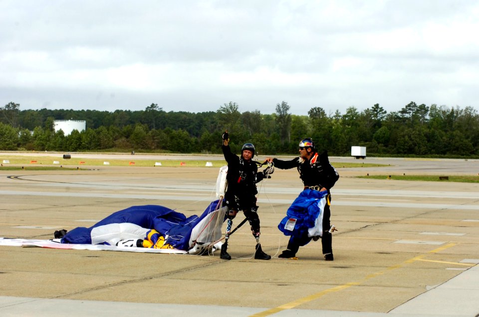 US Navy 070909-N-6676S-569 Dana Bowman, a Blackwater USA Parachute Team member, waves to spectators after landing at the 2007 Naval Air Station Oceana Air Show