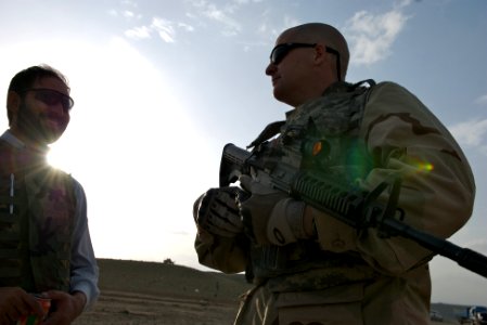 US Navy 070908-N-3385W-076 Chief Petty Officer Patrick Flynn, of Provincial Reconstruction Team Khost, talks to an interpreter working with coalition forces during a ceremony marking the beginning of construction on a four-kilo