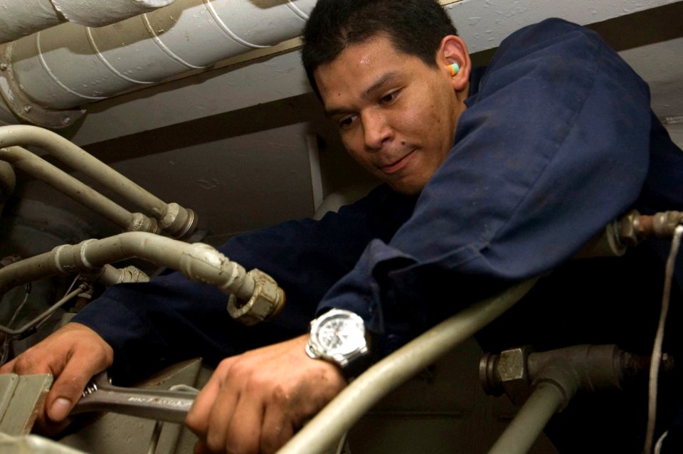 US Navy 070914-N-5387K-009 Machinist's Mate 3rd Class Cesar Caceres does maintenance on a high-pressure air compressor (HPAC) in the cryogenic shop aboard USS Kitty Hawk (CV 63)