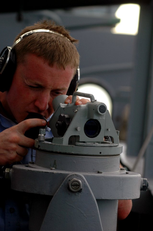 US Navy 070915-N-5148B-053 Quartermaster Seaman Clayton Lambert looks through the alidade telescope aboard nuclear-powered aircraft carrier USS Nimitz (CVN 68) as the ship gets underway from Guam