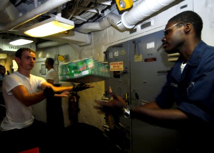 US Navy 070909-N-0841E-376 Sailors aboard guided-missile frigate USS Carr (FFG 52) help store supplies during a vertical replenishment with Military Sealift Command fleet replenishment oiler USNS Tippecanoe (T-AO 199)