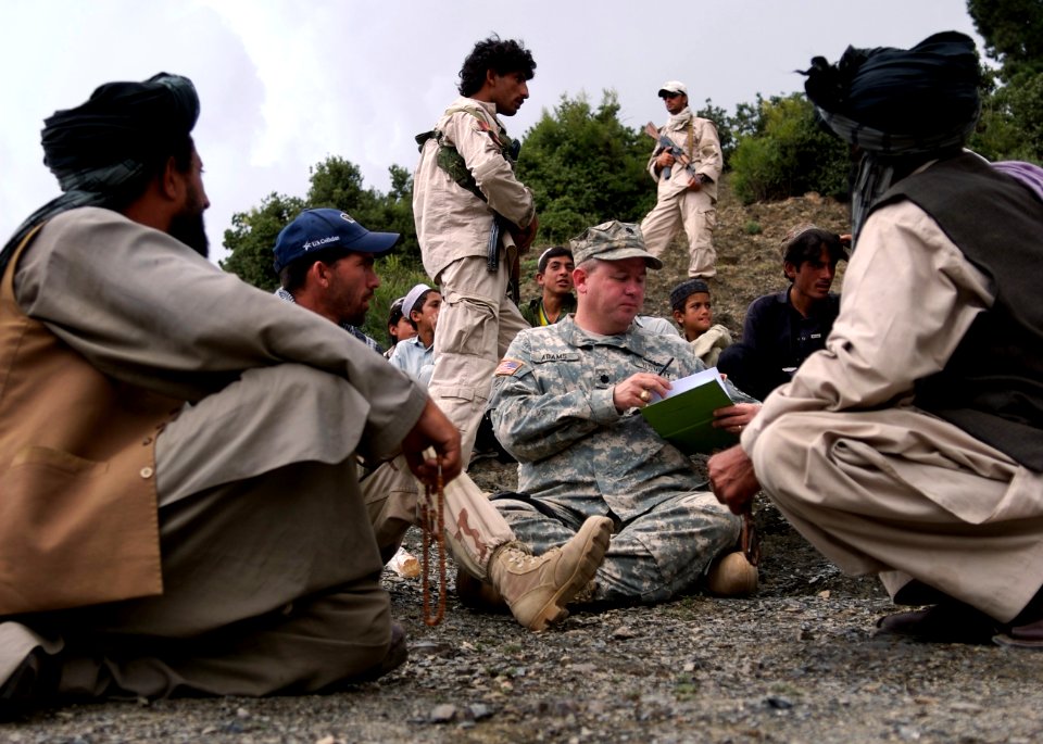 US Navy 070909-N-3385W-033 Cmdr. Dave Adams, commanding officer of Provincial Reconstruction Team Khost, holds an impromptu shura with village elders to discuss recent attacks on a local municipal building