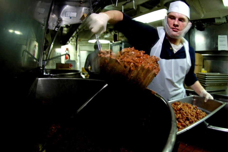 US Navy 070916-N-7883G-001 Culinary Specialist Seaman Casey Steinhauer, of Huble, Texas, prepares carne guisada in the aft galley aboard USS Kitty Hawk (CV 63)
