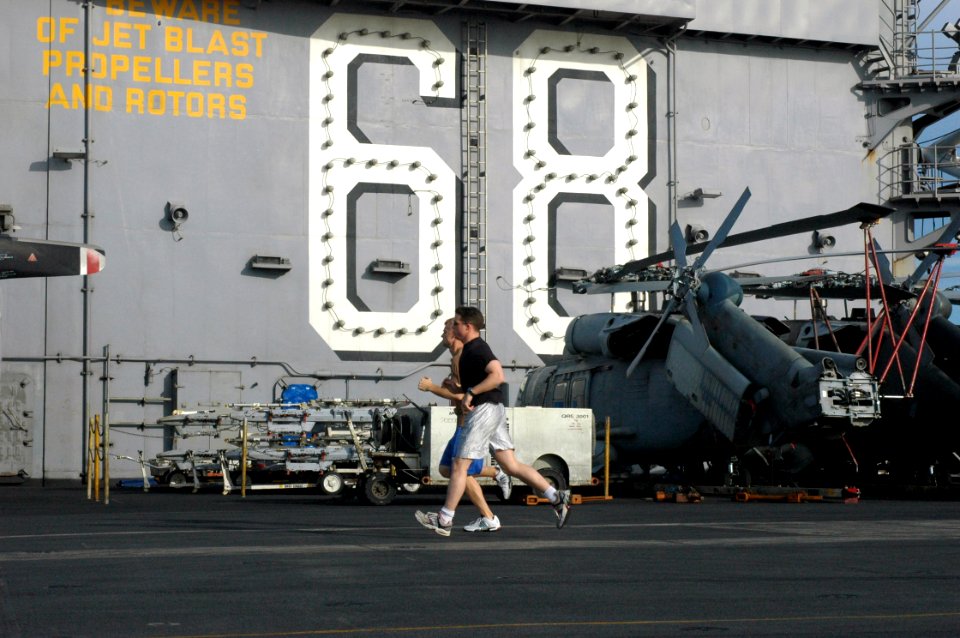 US Navy 070909-N-5148B-114 Sailors aboard aircraft carrier USS Nimitz (CVN 68) train for the Navy's semi-annual physical fitness test by jogging on the ship's flight deck